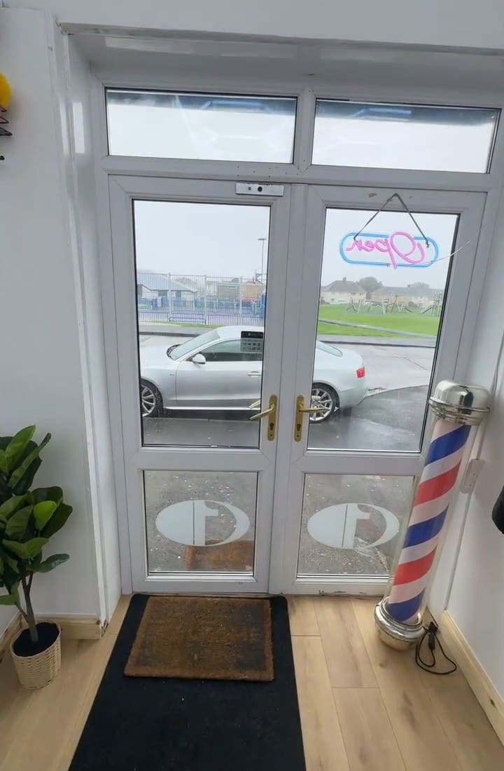 The front door with the barber pole and Open sign